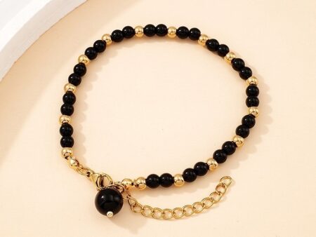 Pulsera dorada piedras negras