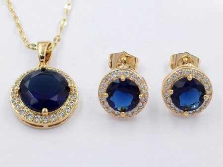 Set dorado dije y aretes piedra azul al centro